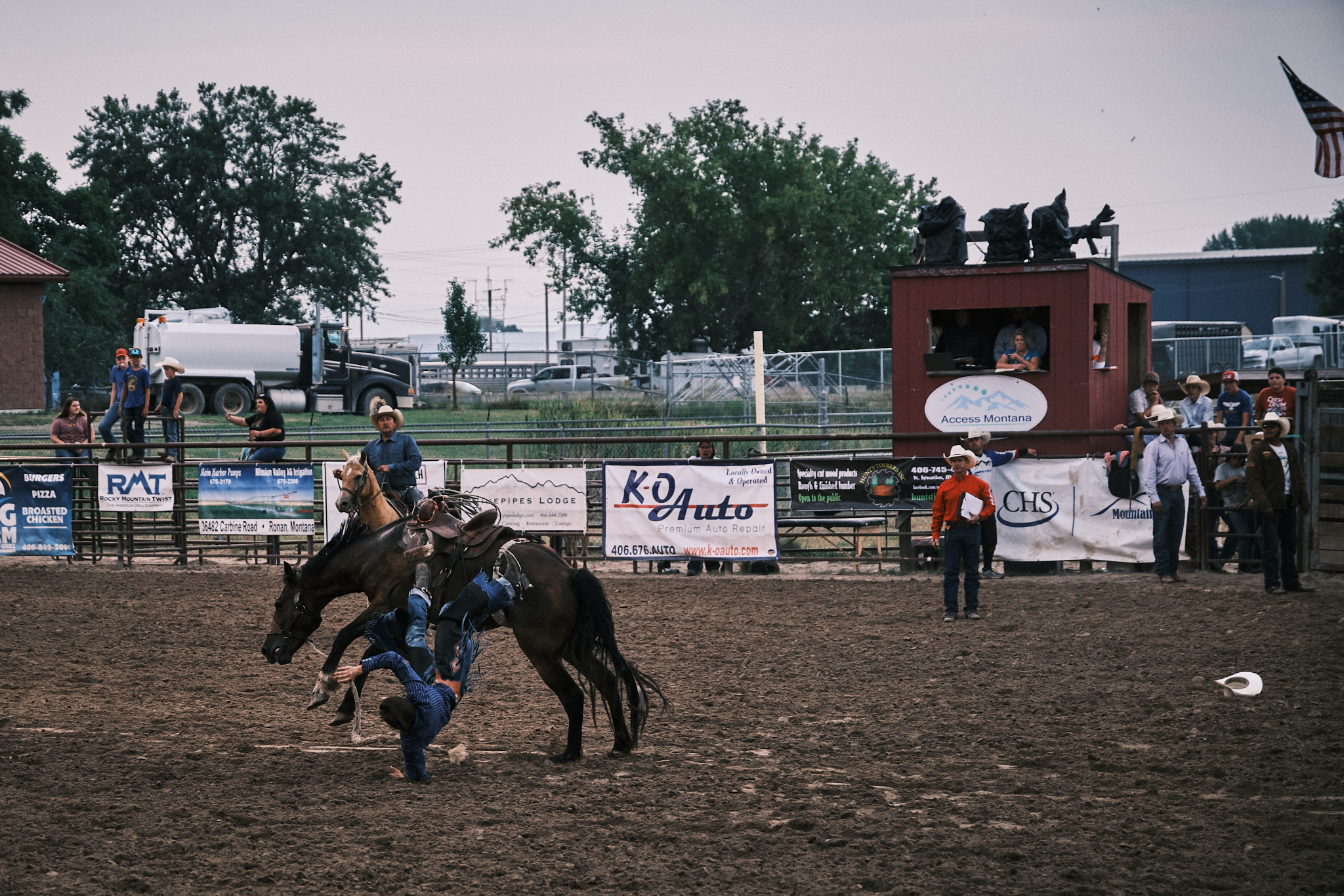 A cowboy falling off his horse and landing on his left arm first