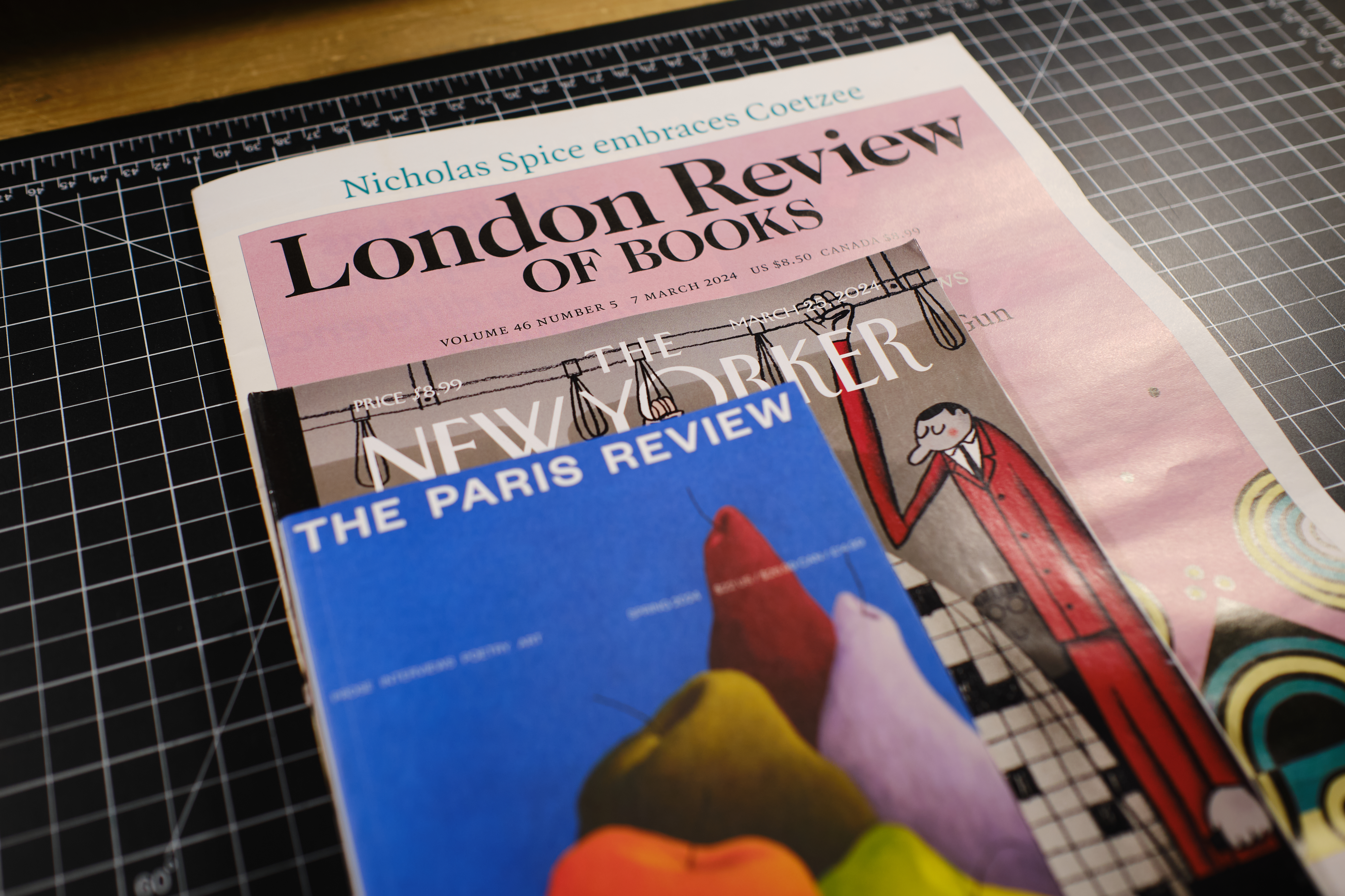 The London of Review of Books, The New Yorker, and the Paris Review stacked atop each other on a desk