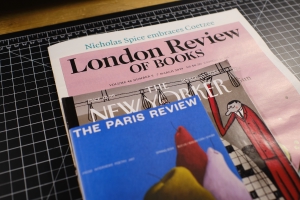 The London of Review of Books, The New Yorker, and the Paris Review stacked atop each other on a desk