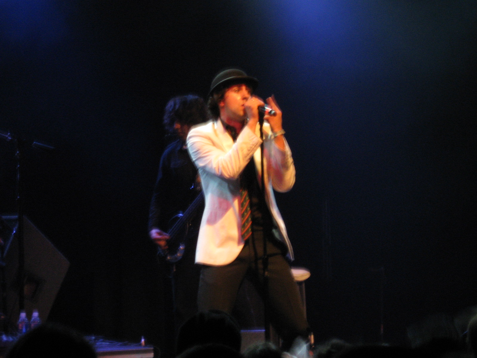 Maxïmo Park singer Paul Smith singing into a microphone at a concert